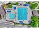 Aerial shot of a swimming pool and diving pool with many lounge chairs around them for a recreational summer day at 302 Northridge Rd, Highlands Ranch, CO 80126