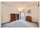 Bedroom boasts neutral carpet, bookshelf, natural light from window, and decorative details at 9001 W Chatfield Dr, Littleton, CO 80128