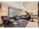 Spacious living room featuring plush sofas, a large window, and an open view into the kitchen area at 9001 W Chatfield Dr, Littleton, CO 80128