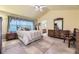 Bright primary bedroom with vaulted ceiling, comfortable bed, dresser, and views to ensuite bath at 9001 W Chatfield Dr, Littleton, CO 80128