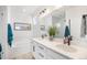 Bright bathroom with double vanity, large mirror, soaking tub, and walk-in shower with clear glass door at 7889 Yampa River Ave, Littleton, CO 80125