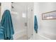 Modern bathroom featuring a glass-enclosed shower with a bench, a soaking tub, and tiled walls at 7889 Yampa River Ave, Littleton, CO 80125