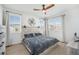 Cozy bedroom with lots of natural light and a wooden headboard with a decorative wall art at 7889 Yampa River Ave, Littleton, CO 80125