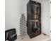 Well organized laundry room featuring a stackable washer and dryer with a laundry basket at 7889 Yampa River Ave, Littleton, CO 80125