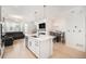 Open-concept living space with kitchen island, comfortable seating, and a modern dining area at 7889 Yampa River Ave, Littleton, CO 80125