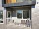 This comfortable balcony with chairs and a grill offers outdoor living and scenic views at 1898 S Bannock St # 404, Denver, CO 80223