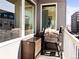 This cozy condo balcony includes a grill and wicker storage, perfect for outdoor relaxation at 1898 S Bannock St # 404, Denver, CO 80223