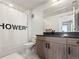 Functional bathroom featuring a shower, toilet, and vanity with a dark countertop at 1898 S Bannock St # 404, Denver, CO 80223