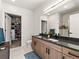 Modern bathroom with double vanity, walk-in shower, and access to a well-organized walk-in closet at 1898 S Bannock St # 404, Denver, CO 80223