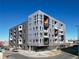 Modern apartment building featuring striking architecture, balconies, and convenient street access at 1898 S Bannock St # 404, Denver, CO 80223