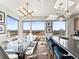 Modern kitchen featuring a sleek island with seating, contemporary lighting, and scenic city views at 1898 S Bannock St # 404, Denver, CO 80223