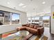 Bright, open living room with a comfortable leather sofa, modern decor, and scenic city views at 1898 S Bannock St # 404, Denver, CO 80223