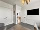 Bright office featuring a large TV, access to additional closets, and an open doorway at 1898 S Bannock St # 404, Denver, CO 80223
