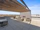 Expansive rooftop deck with pergola, outdoor seating, fireplace, and panoramic views of the city skyline at 1898 S Bannock St # 404, Denver, CO 80223