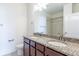 The bathroom features a granite double vanity at 4605 Copeland Loop # 103, Highlands Ranch, CO 80126