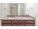 The bathroom features a granite double vanity and a tiled shower at 4605 Copeland Loop # 103, Highlands Ranch, CO 80126