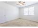 This bedroom features neutral carpeting and a window at 4605 Copeland Loop # 103, Highlands Ranch, CO 80126