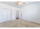 This bedroom features neutral carpeting, ceiling fan, and closet at 4605 Copeland Loop # 103, Highlands Ranch, CO 80126