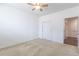 This bedroom features neutral carpeting, ceiling fan, and closet at 4605 Copeland Loop # 103, Highlands Ranch, CO 80126