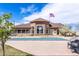 Rear exterior view of the community clubhouse, pool with cover, and outdoor seating at 4605 Copeland Loop # 103, Highlands Ranch, CO 80126
