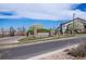 Stone signage at Shadow Canyon community entrance with manicured landscaping under a blue sky at 4605 Copeland Loop # 103, Highlands Ranch, CO 80126