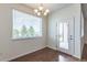 Dining area featuring a chandelier, wood flooring and natural light at 4605 Copeland Loop # 103, Highlands Ranch, CO 80126