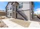 Stylish two-story townhouse with modern exterior, clean landscaping, and stairs to the unit's front door at 4605 Copeland Loop # 103, Highlands Ranch, CO 80126