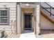 Inviting front door with covered entrance, stairs, and neutral exterior paint scheme at 4605 Copeland Loop # 103, Highlands Ranch, CO 80126