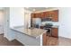 Modern kitchen with granite countertops, stainless steel appliances and wood cabinetry at 4605 Copeland Loop # 103, Highlands Ranch, CO 80126