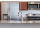 Close up on kitchen with granite counters, stainless appliances, sink and faucet at 4605 Copeland Loop # 103, Highlands Ranch, CO 80126