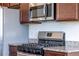 Stainless steel gas range stove top and microwave in modern kitchen at 4605 Copeland Loop # 103, Highlands Ranch, CO 80126