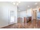 Open floor plan showcasing living room and kitchen with wood floors and ample natural light at 4605 Copeland Loop # 103, Highlands Ranch, CO 80126