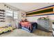 Comfortable bedroom with fun decor, a large window, and ample storage at 14315 Big Stone Dr, Parker, CO 80134