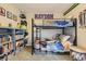 A bedroom features a bunk bed, playful decor, and ample storage with shelving at 14315 Big Stone Dr, Parker, CO 80134