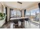 Elegant dining room with modern chandelier, dark wood flooring, and backyard access at 14315 Big Stone Dr, Parker, CO 80134