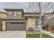 Inviting two-story home featuring a well-manicured lawn and an attached two-car garage at 14315 Big Stone Dr, Parker, CO 80134