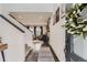 Inviting entryway with hardwood floors, modern decor, and an open staircase at 14315 Big Stone Dr, Parker, CO 80134