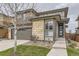 Charming two-story home featuring a two-car garage and stylish stone accents at 14315 Big Stone Dr, Parker, CO 80134