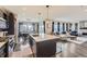 Open-concept kitchen with island, pendant lighting, and stainless steel appliances at 14315 Big Stone Dr, Parker, CO 80134