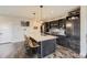 Bright kitchen with island seating, stainless steel appliances, and ample cabinet space at 14315 Big Stone Dr, Parker, CO 80134