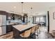 Modern kitchen featuring a large island, stylish lighting, and stainless steel appliances at 14315 Big Stone Dr, Parker, CO 80134