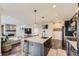 Well-lit kitchen featuring a marble countertop island and stainless steel appliances at 14315 Big Stone Dr, Parker, CO 80134