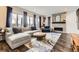 Modern living room with large windows, stylish furniture, fireplace, and decorative rug at 14315 Big Stone Dr, Parker, CO 80134
