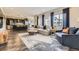 Spacious living room with large windows, hardwood floors, and modern furnishings at 14315 Big Stone Dr, Parker, CO 80134