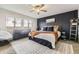 Serene main bedroom showcasing a decorative accent wall, stylish furniture, and lots of natural light at 14315 Big Stone Dr, Parker, CO 80134