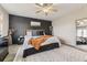 Stylish main bedroom with a dark accent wall, modern furniture, and soft patterned rug at 14315 Big Stone Dr, Parker, CO 80134
