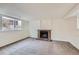 Finished basement with a brick fireplace, neutral carpeting, and a large window at 9526 Pinebrook St, Highlands Ranch, CO 80130