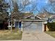 Charming home with a blue front door, gray siding, and a two-car garage at 9526 Pinebrook St, Highlands Ranch, CO 80130