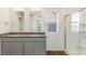 Bathroom featuring a double vanity with granite countertops and a glass shower at 2231 Crosswind St, Fort Lupton, CO 80621