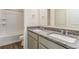 Bathroom featuring double sinks, granite counters, and tub shower at 2231 Crosswind St, Fort Lupton, CO 80621